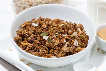 homemade chocolate granola, peanut butter and milk, closeup