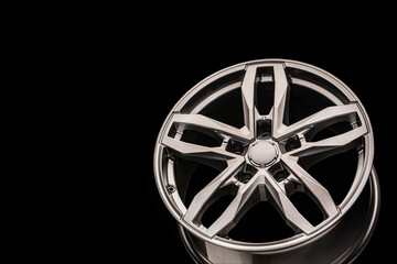 silver SUV Allloy wheel, close-up on a black background