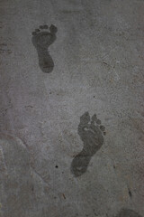 wet footprints standing on rough surface, steps