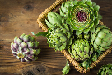 Fresh and raw artichoke on the wooden table