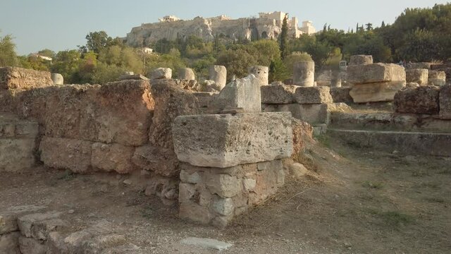 Eye level view of the Acropolis of Athens between ruins of the ancient Agora. Unesco World Heritage monument