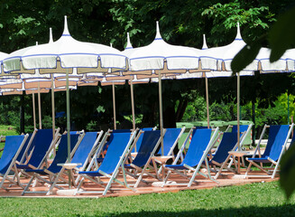 equipped area in the park with deckchairs and umbrellas