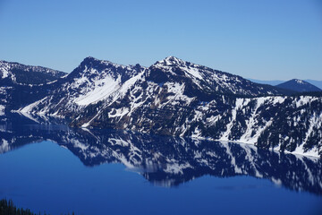 Reflection of snow-capped mountains in Crater Lake National Park (Oregon, USA)