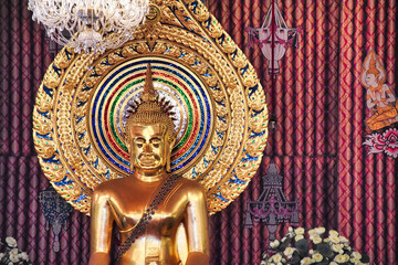 Fototapeta na wymiar A beautiful ornate golden Buddha statue Wat Chana Songkhram temple