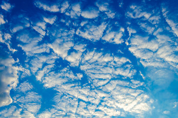 White clouds against a blue sky.