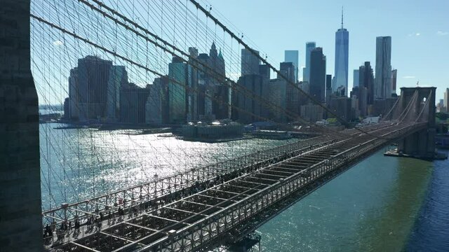 flying backward view of BLM marchers streaming across Brooklyn Bridge towards NYC