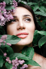 1 white beautiful woman brunette among lilac flowers