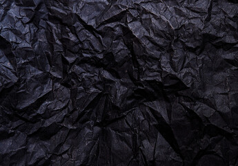 Abstract black paper wrinkled background.
