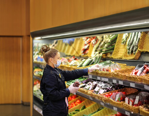 Supermarket shopping, face mask and gloves,Woman buying vegetables at the market	