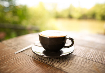 Fototapeta na wymiar Hot mocha coffee or Cappuccino in the brown cup
