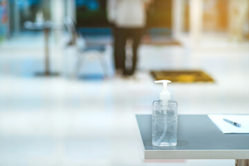 Clear alcohol gel bottles for hand cleaning to prevent the spreading of the corona virus (Covid-19). Place the entrance service with register book for customers before buying in the supermarket.