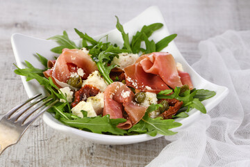 Arugula salad, prosciutto with sun-dried tomatoes