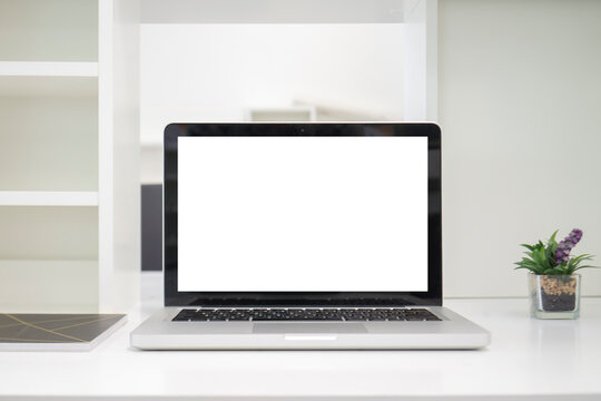 Mock up image of computor laptop with blank white screen background for advertising and text.