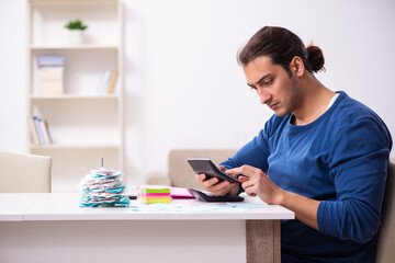 Young man in budget planning concept