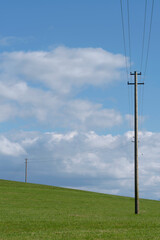 Fototapeta na wymiar Electrical pole on country field