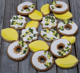 Lemon cookies decorated with royal icing on wooden background
