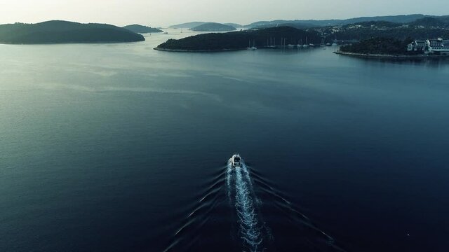 Aerial view of luxury motorboat or speed boat sailing in Mediterranean sea in Europe. Sailing experience on a yacht in France, Monaco, Italy or Croatia.Sun reflection on a calm surface of the sea.