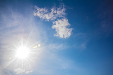 Fototapeta na wymiar Blue Sky with Soft Clouds and Sun