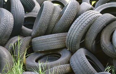 Damaged and worn old black tires on a stack. Damaged and worn old black tires on a stack. Tire...