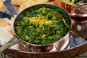 North Indian vegan spinach and lentil curry in traditional serving bowl