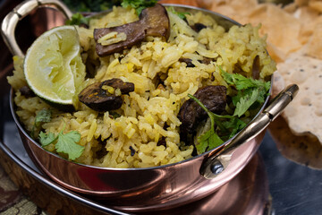 Vegan rice and mushroom pilaf served in traditional bowl close up