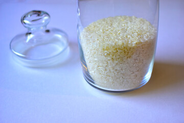 Glass vessel with a lid and white rice inside