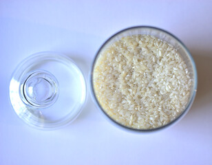 Glass vessel with a lid and white rice inside