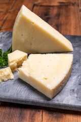 Pieces of matured pecorino romano italian cheese made from sheep milk in Lazio, Sardinia or Tuscany