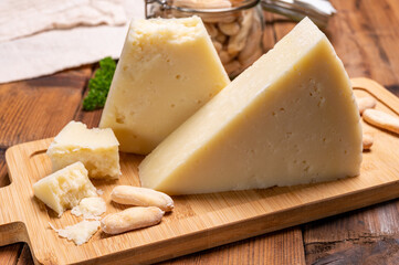 Pieces of matured pecorino romano italian cheese made from sheep milk in Lazio, Sardinia or Tuscany - obrazy, fototapety, plakaty