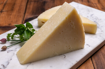 Pieces of matured pecorino romano italian cheese made from sheep milk in Lazio, Sardinia or Tuscany