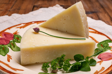Pieces of matured pecorino romano italian cheese made from sheep milk in Lazio, Sardinia or Tuscany