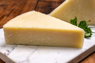 Pieces of matured pecorino romano italian cheese made from sheep milk in Lazio, Sardinia or Tuscany
