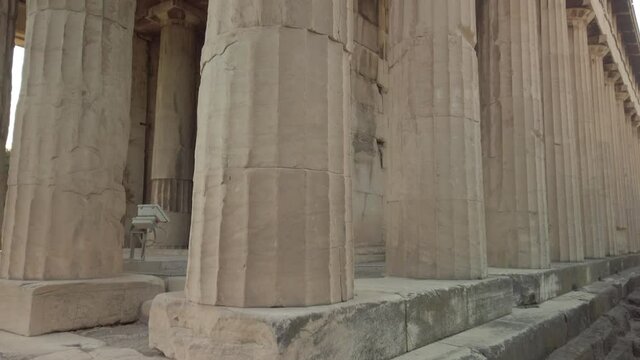 Tilt up and close up view of the Temple of Hephaestus in ancient agora of Athens, Monastiraki district, Greece. The most well-preserved ancient Greek temple. POV view from the base of the temple.