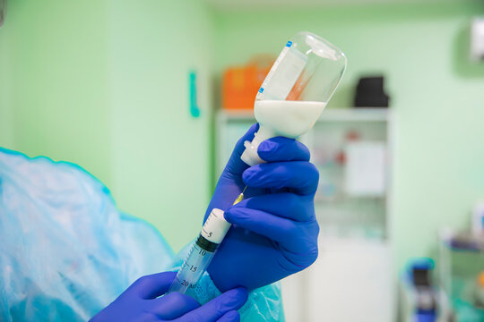 Doctor draws medicine into a syringe