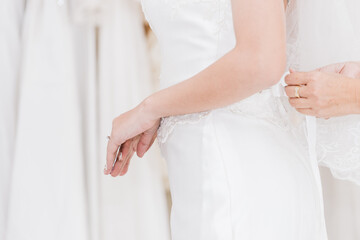 The Asian bride is dressed to attend the wedding ceremony close-up at hip