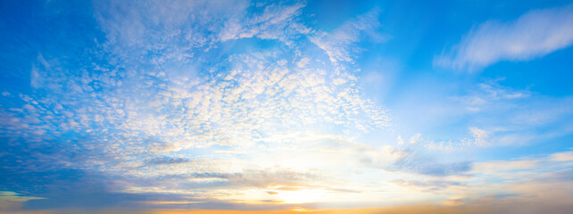 Blue sky clouds background. Beautiful landscape with clouds and orange sun on sky