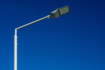 A modern street LED lighting pole. Urban electro-energy technologies. Savings on street urban road lighting. Energy saving. High tech. Eco-friendly smart city system.