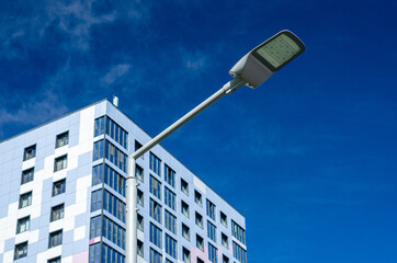A modern street LED lighting pole. Urban electro-energy technologies. Savings on street urban road...