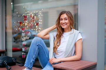 Woman city street summer sitting bench showcase shop window outdoor Modern stylish travel girl with backpack resting happy smiling on city street.