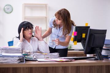 Two female employees and excessive work in the office