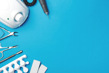 Professional manicure tools on blue background..