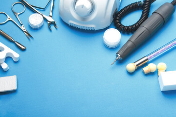 Professional manicure tools on blue background..