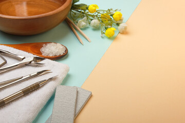 Professional manicure tools on blue and beige background..