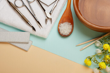 Professional manicure tools on blue and beige background..