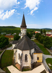 Fototapeta na wymiar Aerial photo about the Church of the Assumption in Gyongyospata Hungary. Historical religious monument. Built in 12th century romanian baroque and gothic style. popular tourist attraction.
