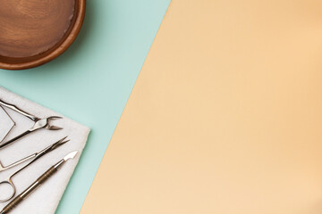 Manicure tools on blue and beige pastel paper.