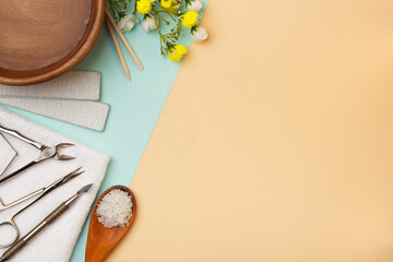 Professional manicure tools on blue and beige background..