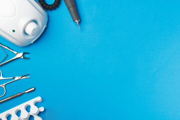 Professional manicure tools on blue background..