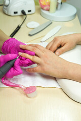 Obraz na płótnie Canvas Close Up shot of a woman in a nail salon receiving a manicure . Woman getting nail manicure by manicure machine