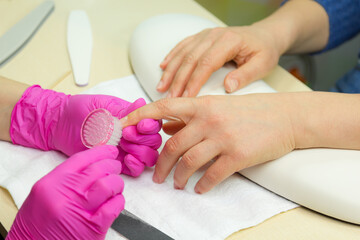 Obraz na płótnie Canvas Closeup shot of a woman in a nail salon receiving a manicure. Woman getting nail manicure. .